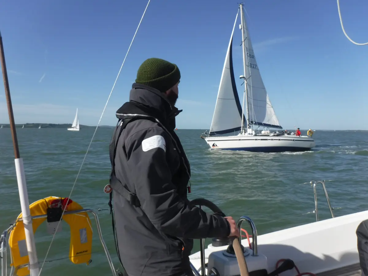 Yacht under sail in central Solent with the Isle of Wight in the distance Beginner sailing in the Solent with First Class Sailing