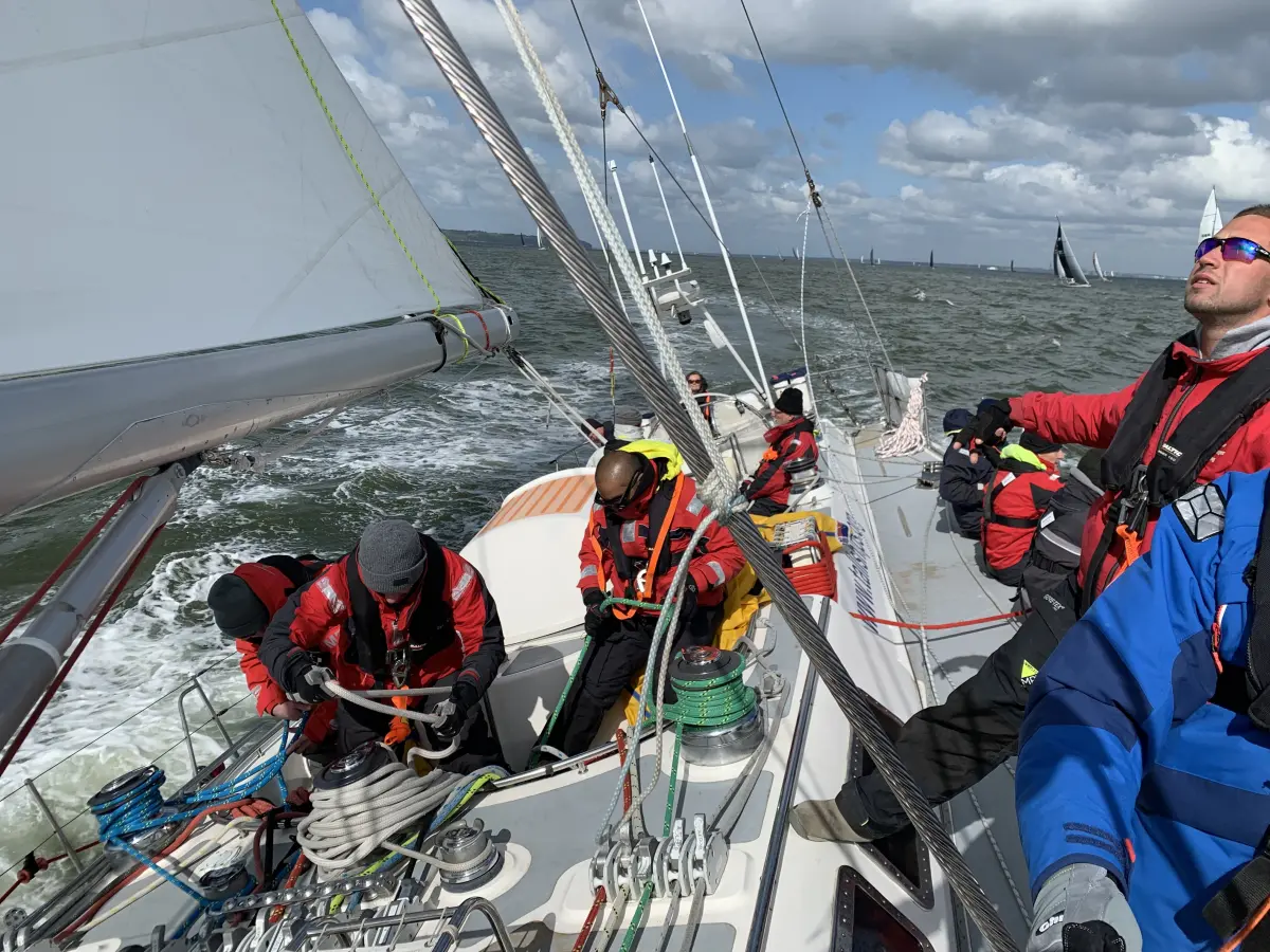 Offshore yacht racing experience with crew working sails in strong winds
