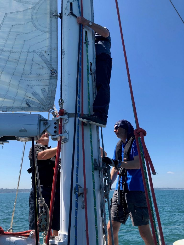 Preparing for the Fastnet climbing up the mast