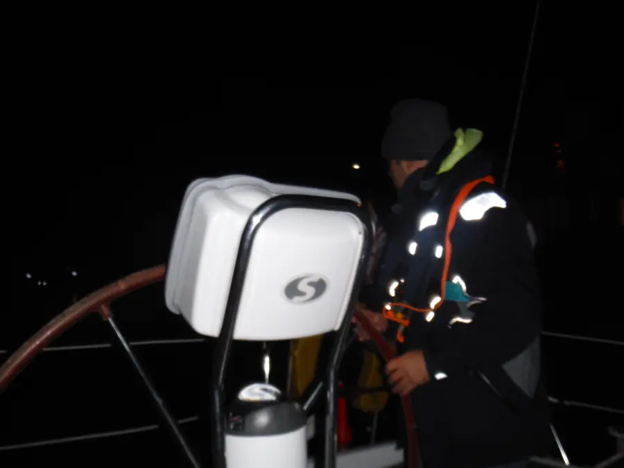 Sailor steering by compass under stars during night watch