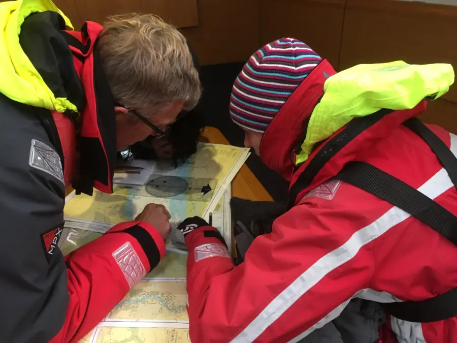 Students planning an offshore passage on a mile building sailing trip