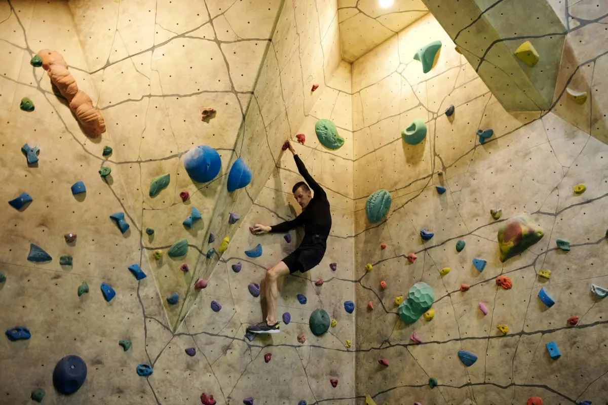Beginner learning the basics of climbing at an indoor centre.