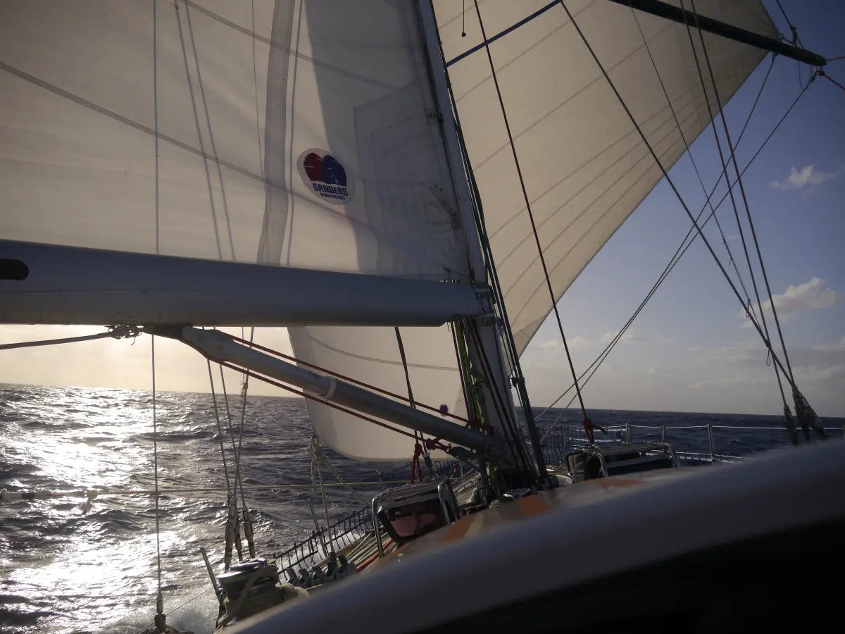 Yacht surfing Atlantic swells under trade winds