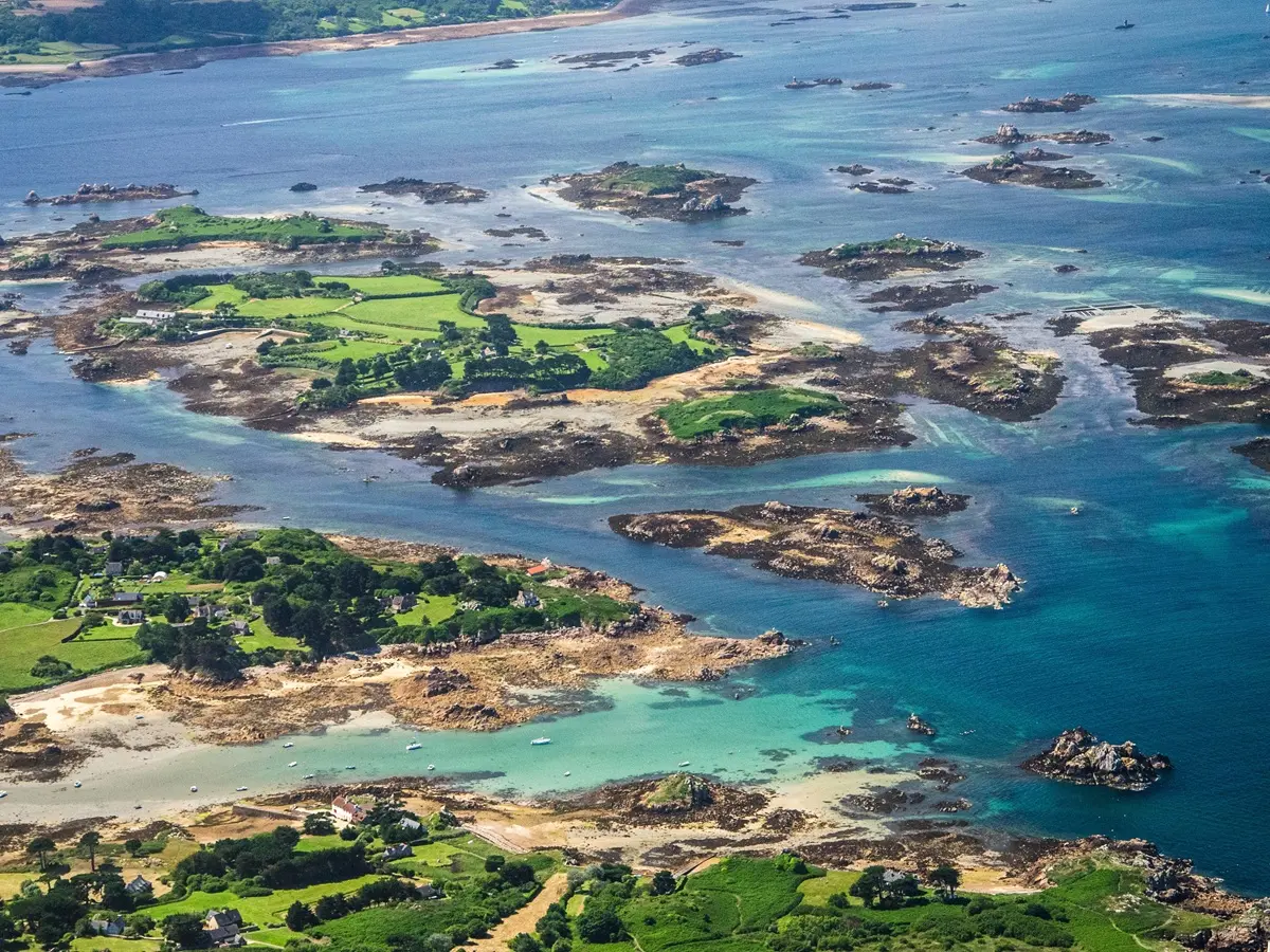Turquoise water and white sand beaches in the Isles of Scilly viewed from above Yachts anchored among the islands of the Isles of Scilly during summer