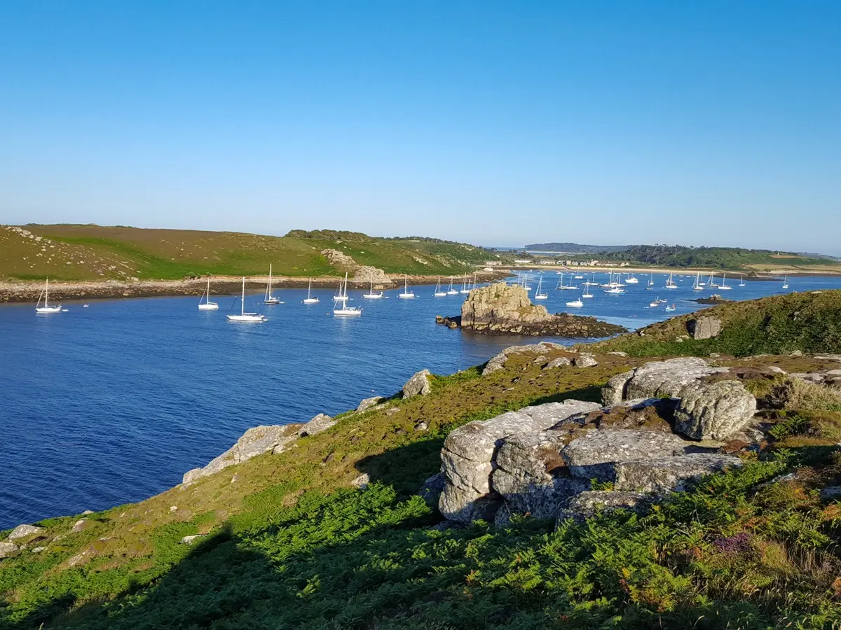 Sailing yacht anchored in the Isles of Scilly during a summer sailing holiday