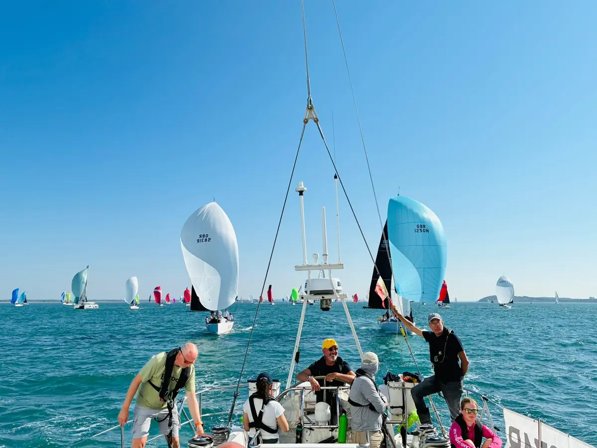 Round the Island 2026 race crew in the cockpit being chased by other yachts