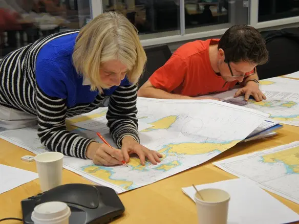 Office-based sailing theory course with navigation equipment on display